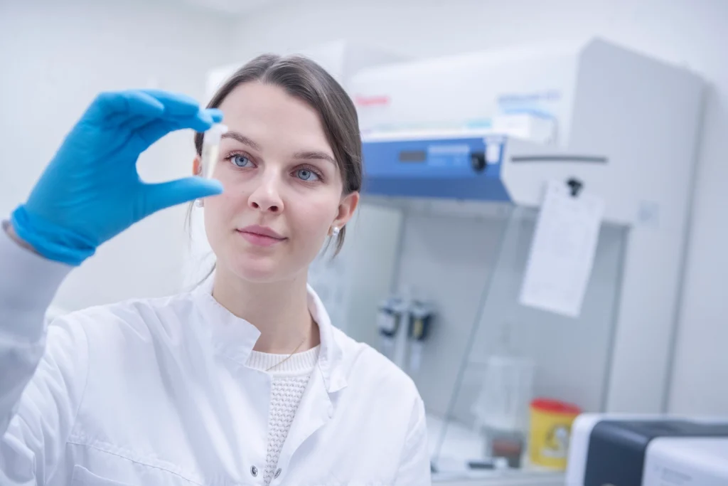 Woman holding up vial