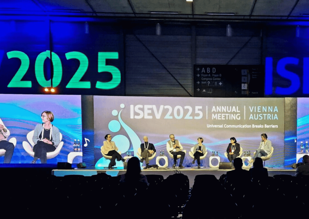 Six panelists seated on stage at the ISEV2025 congress
