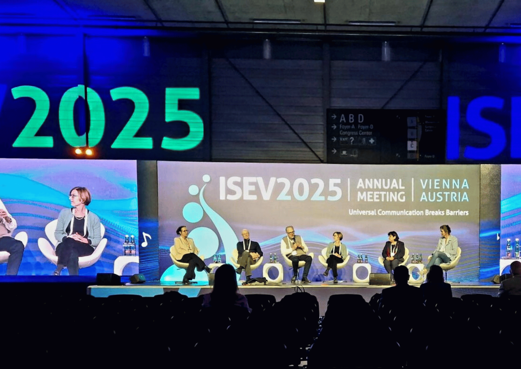Six panelists seated on stage at the ISEV2025 congress