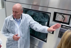 Thomas Beck showing filling machine in NorthX Biologics site, Matfors