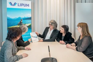 Several NorthX Biologics colleagues talking in a Lipum conference room meeting.